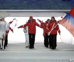 Armenia's flag bearer, cross-country skier Sergey Mikayelyan leads his national delegation during the Opening Ceremony of the Sochi Winter Olympics at the Fisht Olympic Stadium on February 7, 2014 in Sochi.  AFP PHOTO / ANDREJ ISAKOVIC