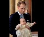 LONDON, ENGLAND - OCTOBER 23:  Prince William, Duke of Cambridge arrives, holding his son Prince George, at Chapel Royal in St James's Palace, ahead of the christening of the three month-old Prince George of Cambridge by the Archbishop of Canterbury on October 23, 2013 in London, England. (Photo by John Stillwell - WPA Pool /Getty Images)