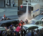 Police use a water cannon to disperse protestors outside Turkish Prime Minister Recep Tayyip Erdogan's working office in Besiktas Istanbul, on June 2, 2013, during a third day of clashes sparked by anger at his Islamist-rooted government.  White fumes filled the air as riot cops fired gas and lashed stone-throwing protestors with water-cannons in the two cities, the latest in a string of nationwide clashes that have left scores injured. AFP PHOTO /OZAN KOSE        (Photo credit should read OZAN KOSE/AFP/Getty Images)